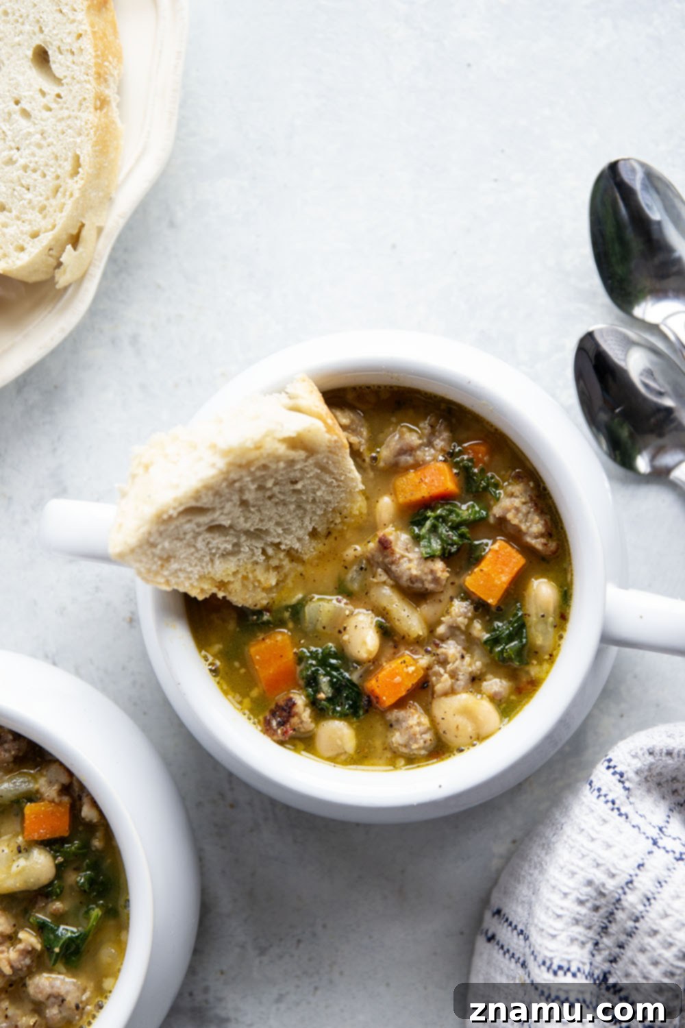 Hearty Miso White Bean And Sausage Kale Soup 2 Savory miso, tender white beans and browned sausage are incredible together in this hearty white bean kale sausage soup! Best paired with a thick wedge of bread for dipping.