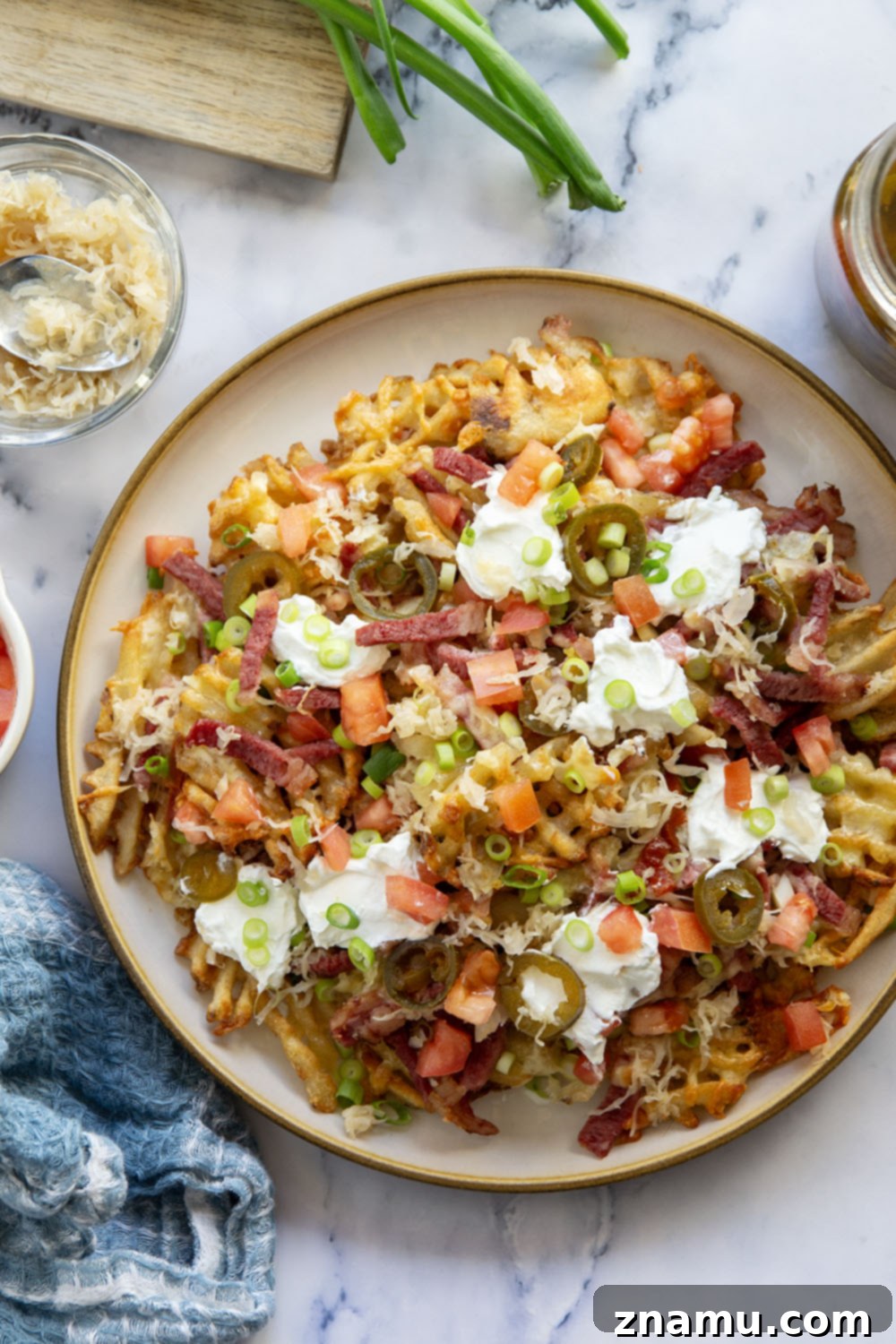 Reuben Nachos 5 These corned beef nachos feature waffle fries that are loaded down with Irish cheddar cheese, corned beef, and tons of toppings for a fun twist on nachos!