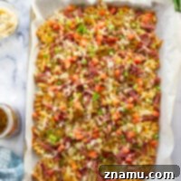 These corned beef nachos feature waffle fries that are loaded down with Irish cheddar cheese, corned beef, and tons of toppings for a fun twist on nachos!