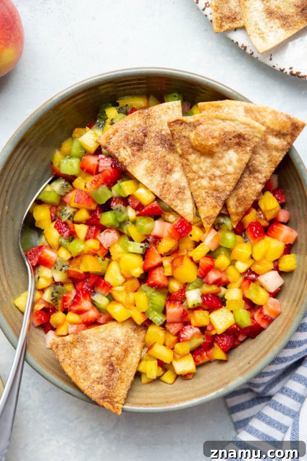 Cinnamon Sugar Crisps with Fresh Fruit Dip 3 Fresh fruit salsa featuring peaches, strawberries, kiwi, and pineapple, served with homemade cinnamon chips.