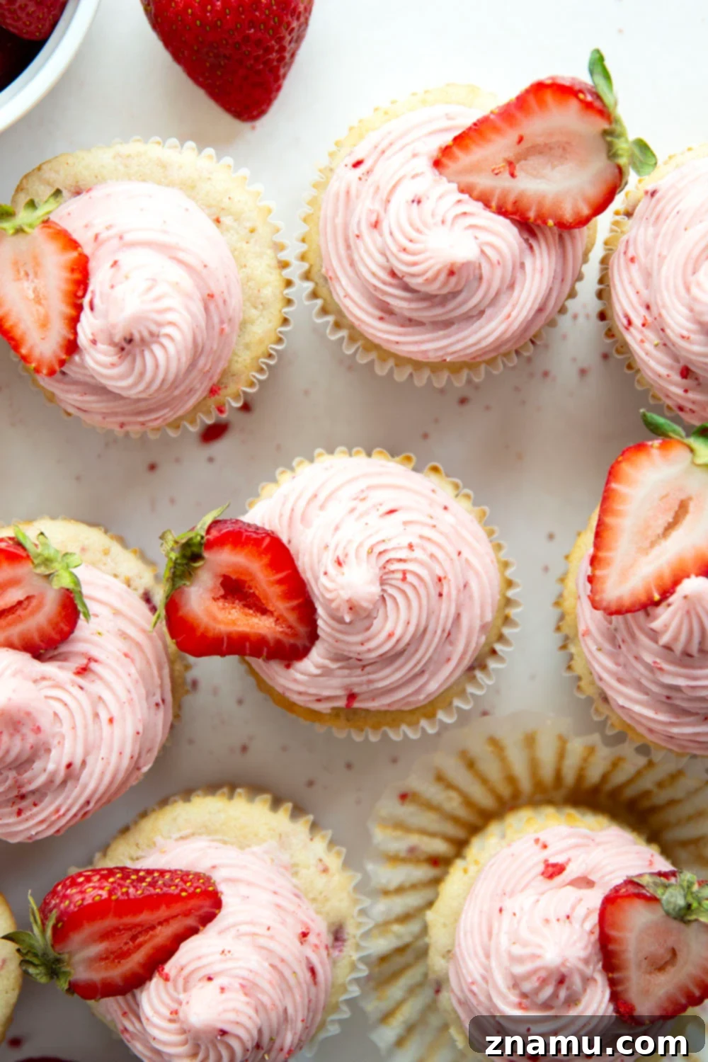 Strawberry Cream Cheese Cupcakes 2 Freshly baked strawberry cupcakes with fluffy strawberry cream cheese frosting on a white plate