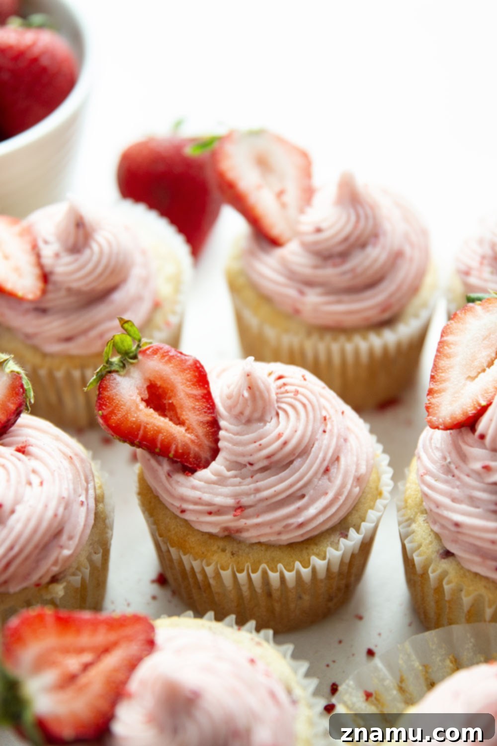 Strawberry Cream Cheese Cupcakes 5 Ingredients for strawberry cupcakes laid out, including fresh strawberries, flour, sugar, and butter