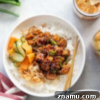 These gochujang tofu bowls feature perfectly crispy tofu tossed in a spicy gochujang sauce and piled high over fluffy rice with pickled vegetables and kimchi.
