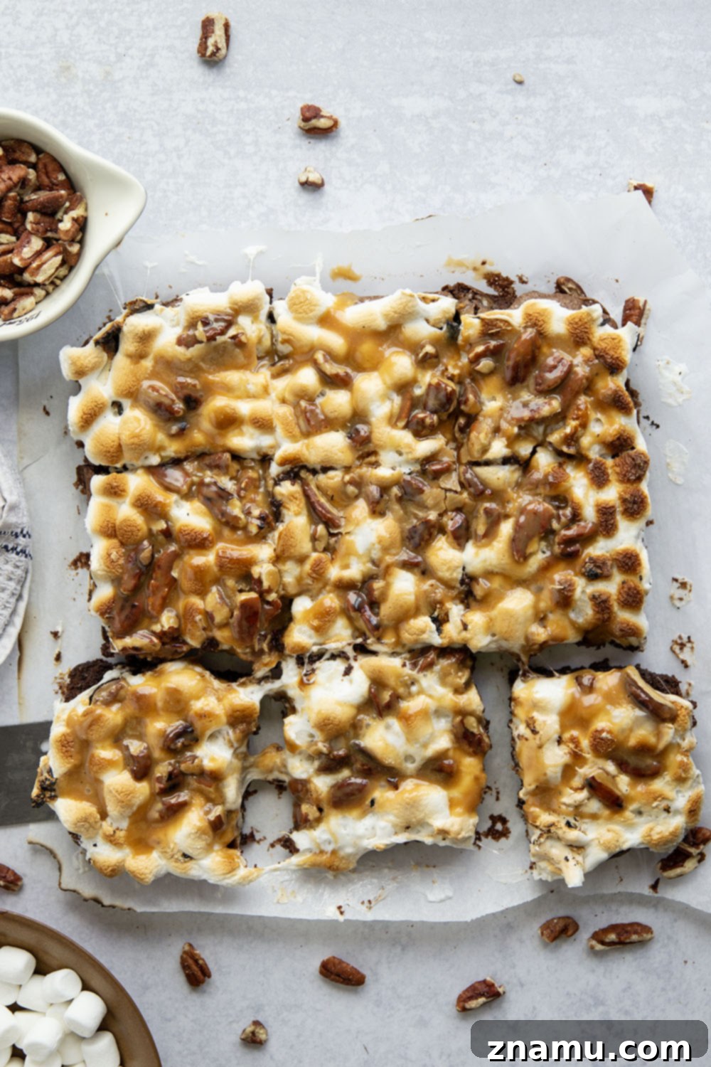 Brownies baking in a pan, topped with mini marshmallows just before broiling to perfection.