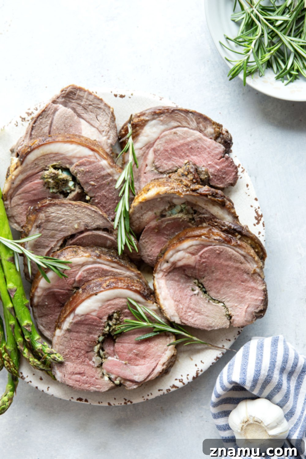 Aromatic Rosemary Garlic Leg of Lamb 2 Stuffed with fresh rosemary and garlic, this perfectly roasted leg of lamb is an impressive and easy centerpiece for any occasion.