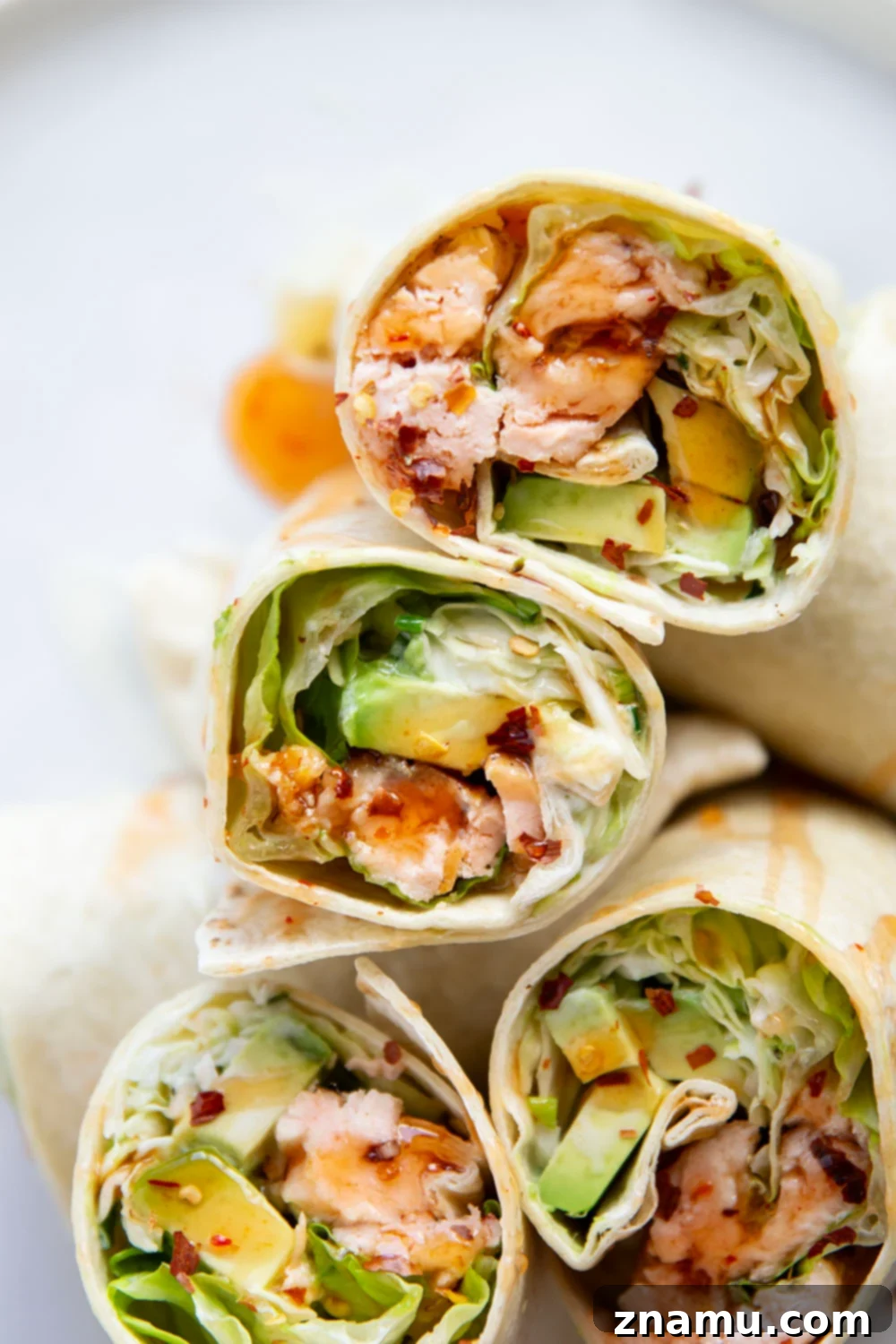 Sweet Heat Salmon Wrap 6 Two halves of a delicious Hot Honey Salmon Wrap, showing the vibrant interior.