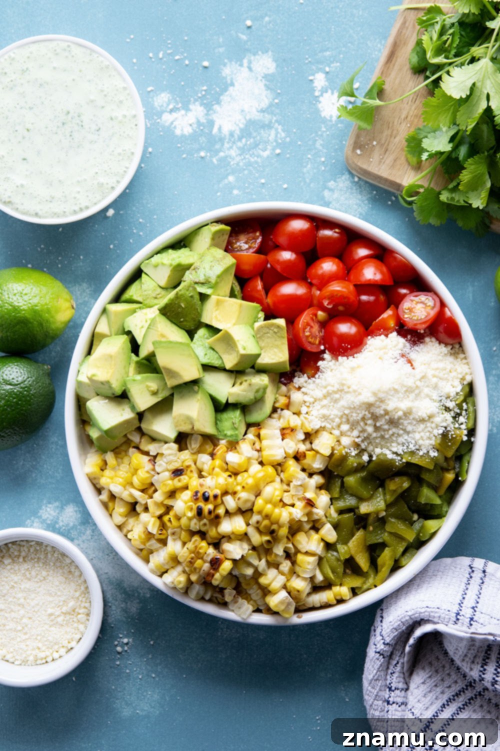 Smoky Poblano Corn Salad with Fresh Cilantro Crema 3 An overhead shot of a bowl of Charred Poblano Corn Salad, highlighting the mix of colorful vegetables.