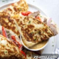 Spicy Chipotle Queso Steak Quesadillas 8 Crispy, cheesy steak quesadillas are stuffed with tender steak and pepper strips and served with a spicy chipotle queso sauce for dipping.