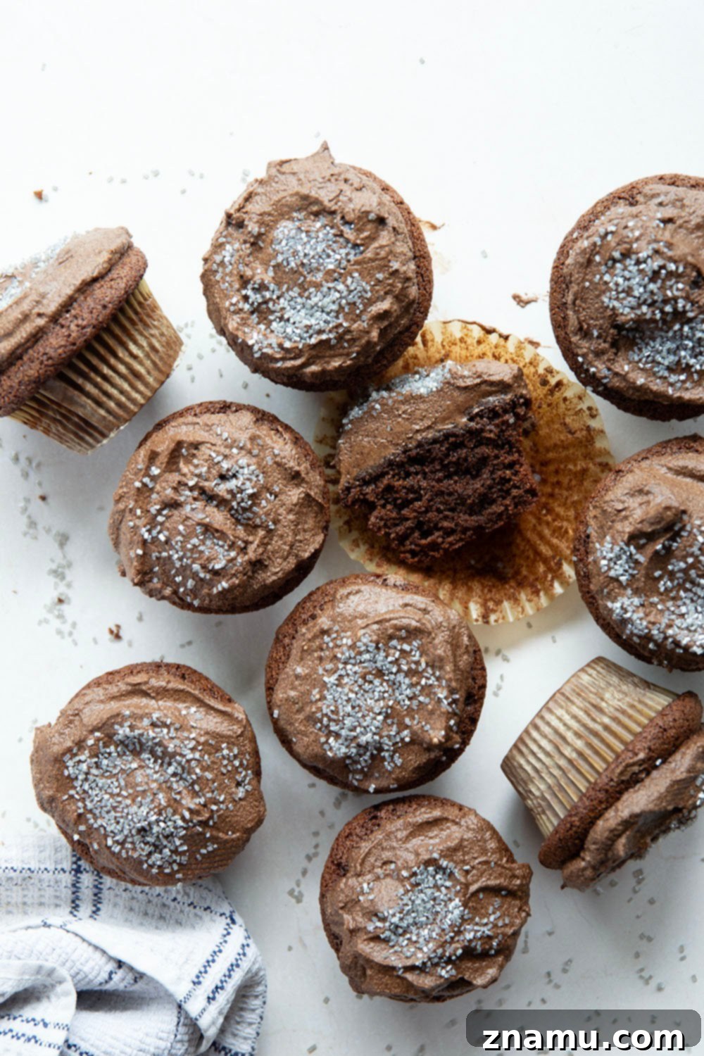 Decadent Gluten-Free Chocolate Cupcakes 5 Multiple gluten-free chocolate cupcakes with whipped ganache and sprinkles on a serving platter.