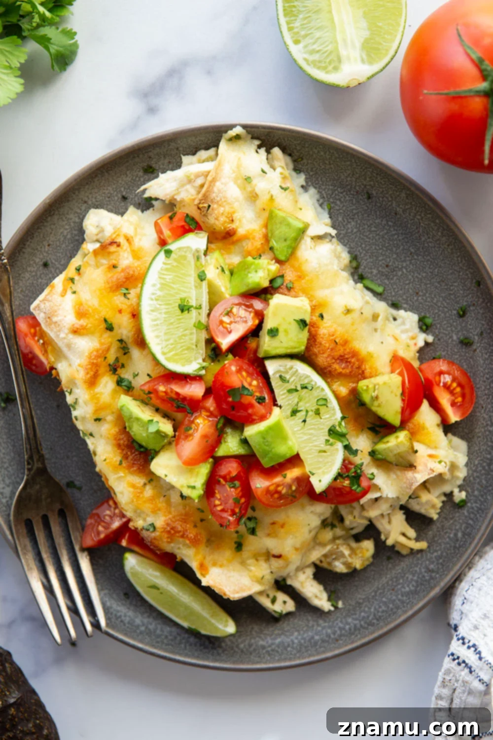 One-Skillet Green Chile Chicken Enchiladas 2 Baked in a creamy salsa verde sauce and stuffed with tender green chile chicken, these skillet green chile chicken enchiladas are piled high with the works!