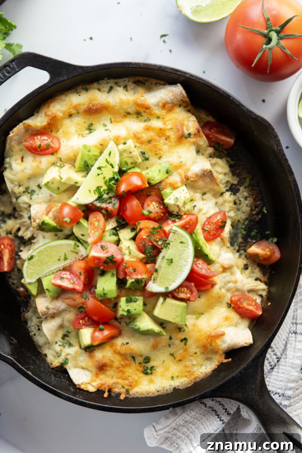 One-Skillet Green Chile Chicken Enchiladas 3 Baked in a creamy salsa verde sauce and stuffed with tender green chile chicken, these skillet green chile chicken enchiladas are piled high with the works!