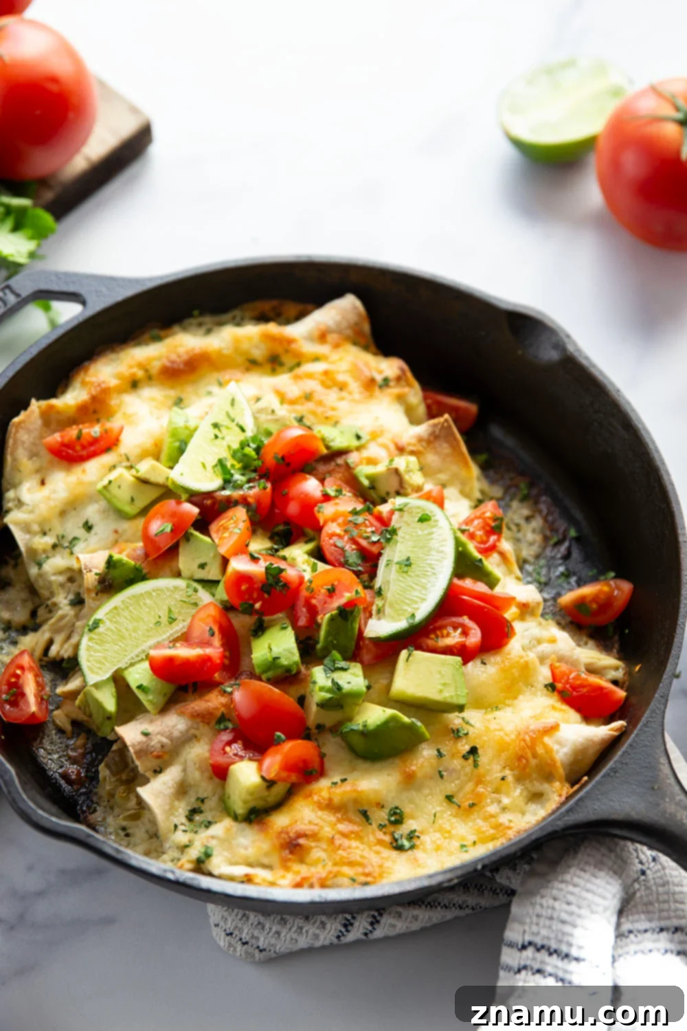 One-Skillet Green Chile Chicken Enchiladas 5 Baked in a creamy salsa verde sauce and stuffed with tender green chile chicken, these skillet green chile chicken enchiladas are piled high with the works!