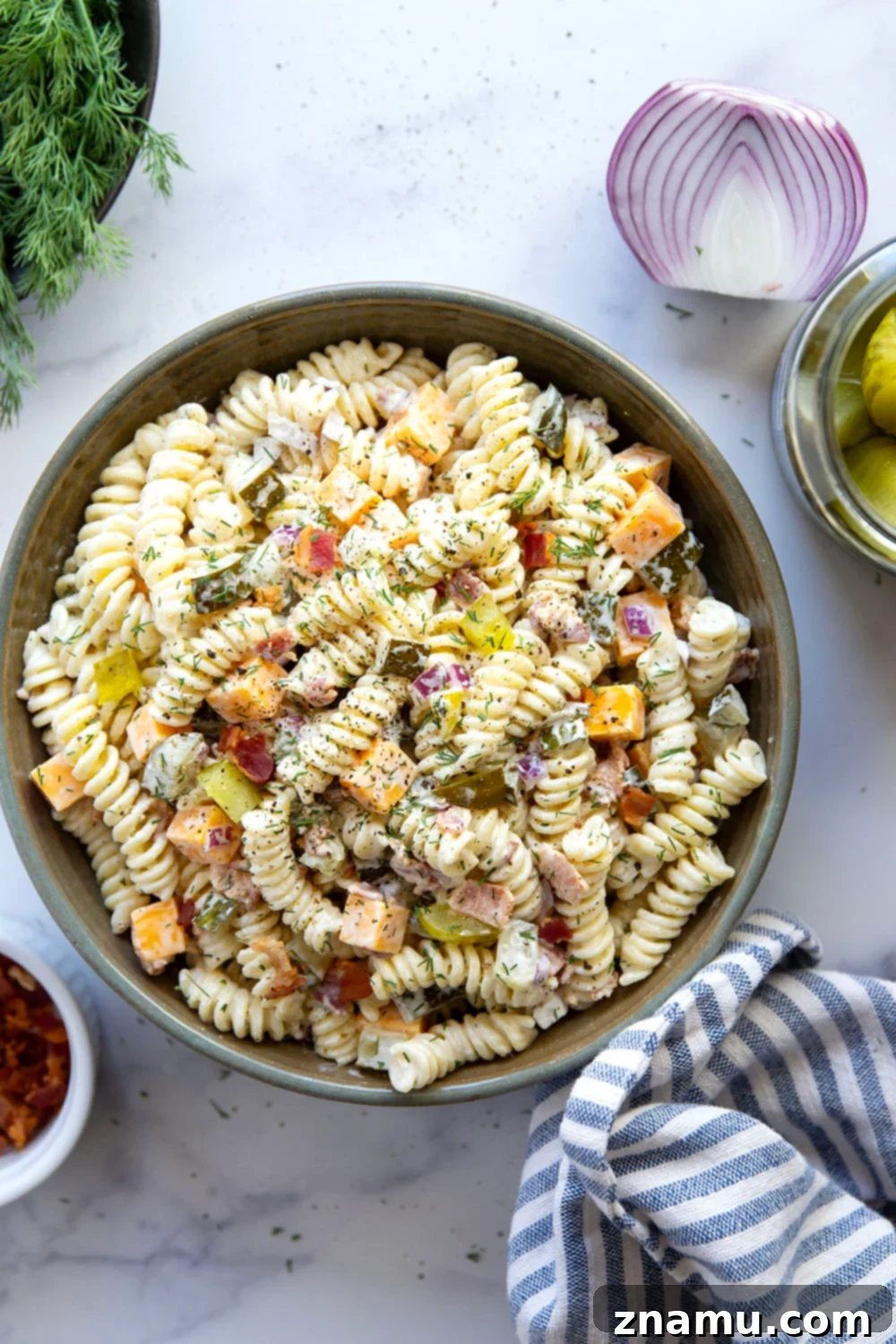 Zesty Bacon Dill Pasta Salad 2 A vibrant dill pickle pasta salad in a large bowl, garnished with fresh dill, ready for serving.