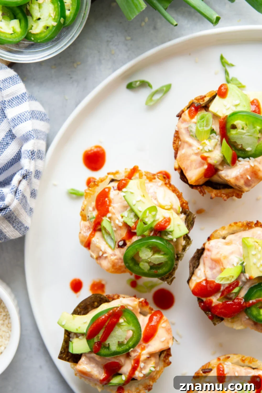 Spicy Salmon Sushi Bites 4 These spicy salmon sushi cups feature crispy rice cups filled with a spicy sriracha salmon filling and topped with lots of fresh avocado and jalapeno.