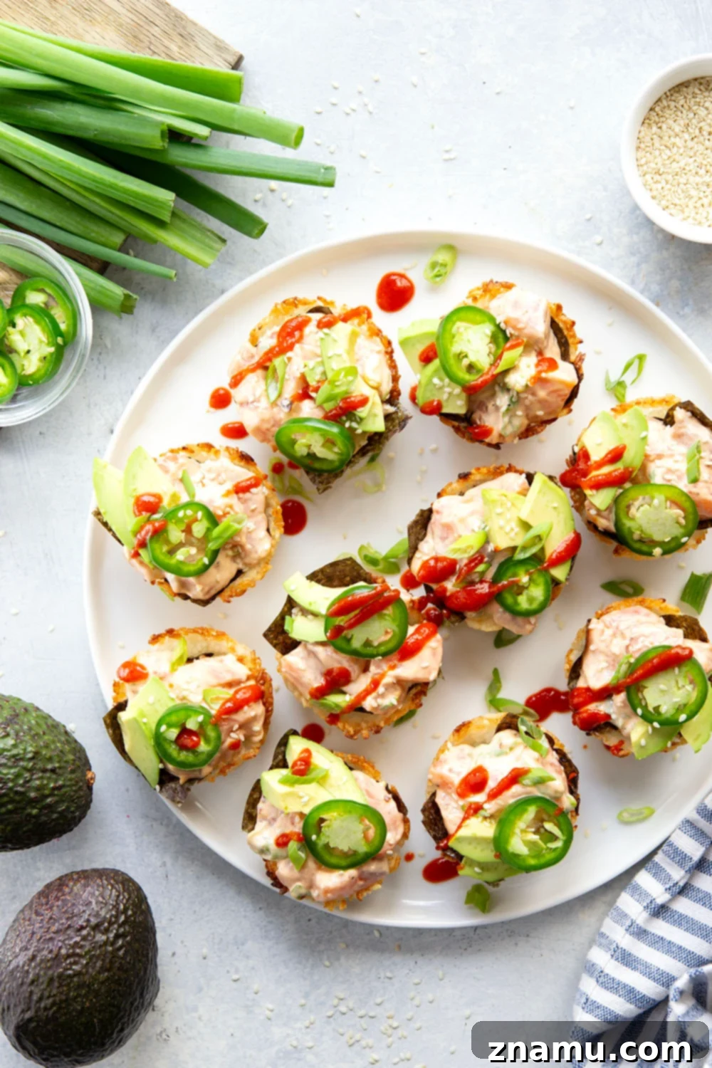 Spicy Salmon Sushi Bites 5 These spicy salmon sushi cups feature crispy rice cups filled with a spicy sriracha salmon filling and topped with lots of fresh avocado and jalapeno.