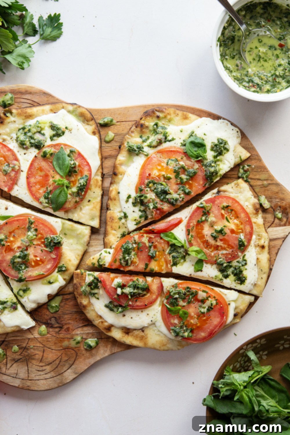 Fire-Kissed Caprese Flatbread with Aromatic Basil Chimichurri 2 Grilled Caprese Flatbread with fresh mozzarella, tomatoes, and basil chimichurri, ready to be served.