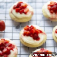 Strawberry Shortcake Cookies with a soft vanilla base, rich cream cheese frosting, and fresh strawberries, perfect for summer.