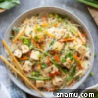 Loaded with a rainbow of fresh veggies and flavorful sweet chili tofu, this vermicelli noodle salad is massively flavorful and goes well with a variety of dishes.