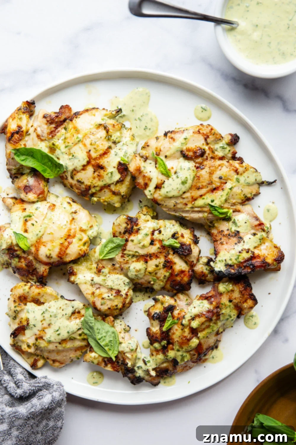Green Goddess Fire-Kissed Chicken 2 This green goddess grilled chicken features juicy chicken thighs marinated in an herby homemade green goddess dressing and grilled until perfectly smoky and tender.