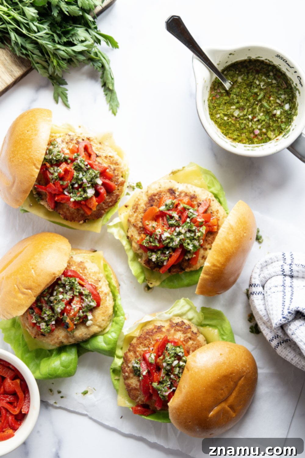 Zesty Chimichurri Turkey Burgers with Roasted Red Pepper and Cheddar 2 Flavorful Cheddar Turkey Burgers with Roasted Red Peppers and Chimichurri Sauce, ideal for summer grilling