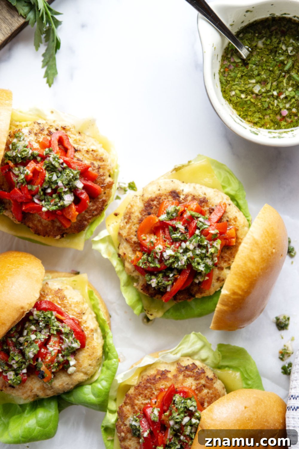 Zesty Chimichurri Turkey Burgers with Roasted Red Pepper and Cheddar 6 Close-up of a finished Cheddar Turkey Burger with chimichurri and red peppers, ready to serve