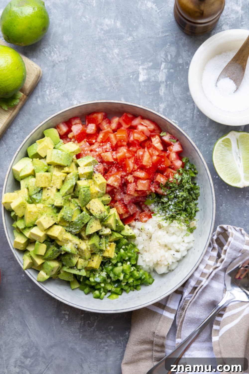 The Ultimate Chunky Avocado Salsa 3 Close-up of the chunky avocado salsa, showcasing the vibrant green of the avocado, the red of the tomatoes, and green specks of cilantro, highlighting its fresh and wholesome ingredients.