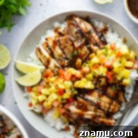 Pineapple marinated chicken thighs, a spicy pineapple salsa, and lots of fluffy rice make for the perfect summer bowls in this grilled pineapple chicken and rice.