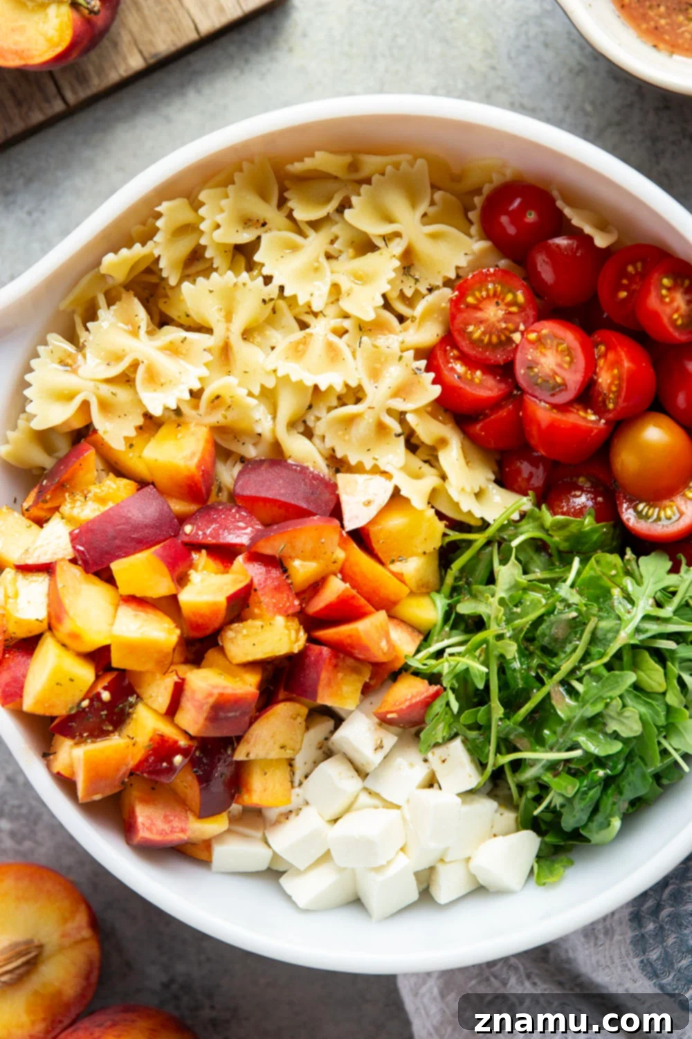 Golden Peach Caprese Pasta 3 Sweet peaches pair perfectly with herby basil, soft mozzarella, juicy cherry tomatoes, and a tangy balsamic dressing in this peach caprese pasta salad.