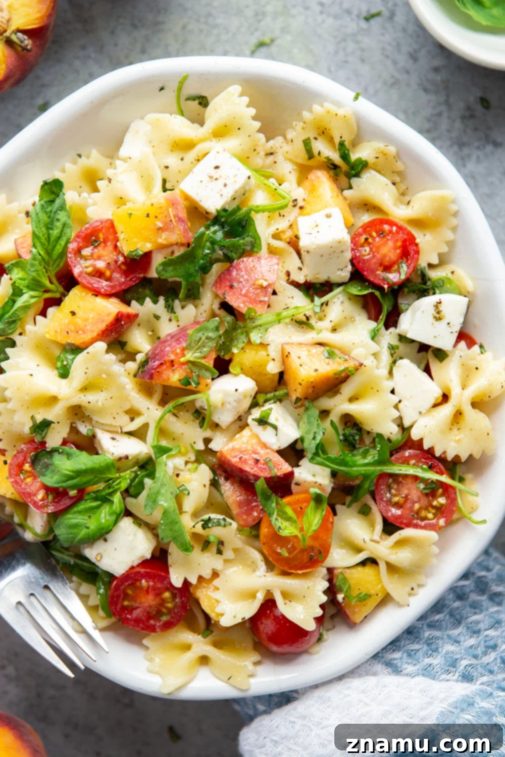 Golden Peach Caprese Pasta 4 Sweet peaches pair perfectly with herby basil, soft mozzarella, juicy cherry tomatoes, and a tangy balsamic dressing in this peach caprese pasta salad.