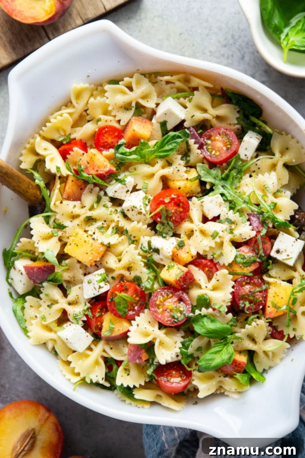 Golden Peach Caprese Pasta 5 Sweet peaches pair perfectly with herby basil, soft mozzarella, juicy cherry tomatoes, and a tangy balsamic dressing in this peach caprese pasta salad.