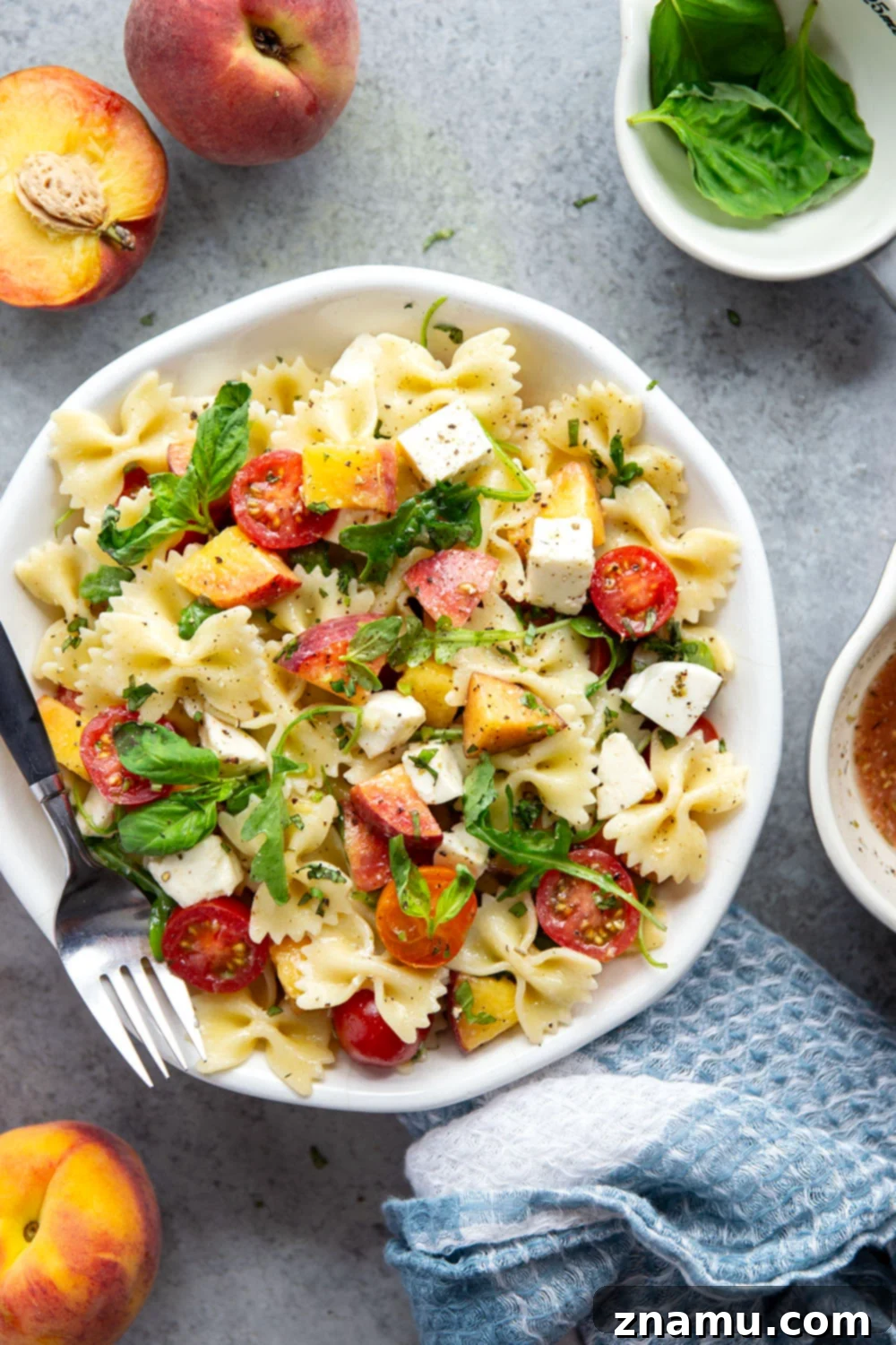 Golden Peach Caprese Pasta 6 Sweet peaches pair perfectly with herby basil, soft mozzarella, juicy cherry tomatoes, and a tangy balsamic dressing in this peach caprese pasta salad.