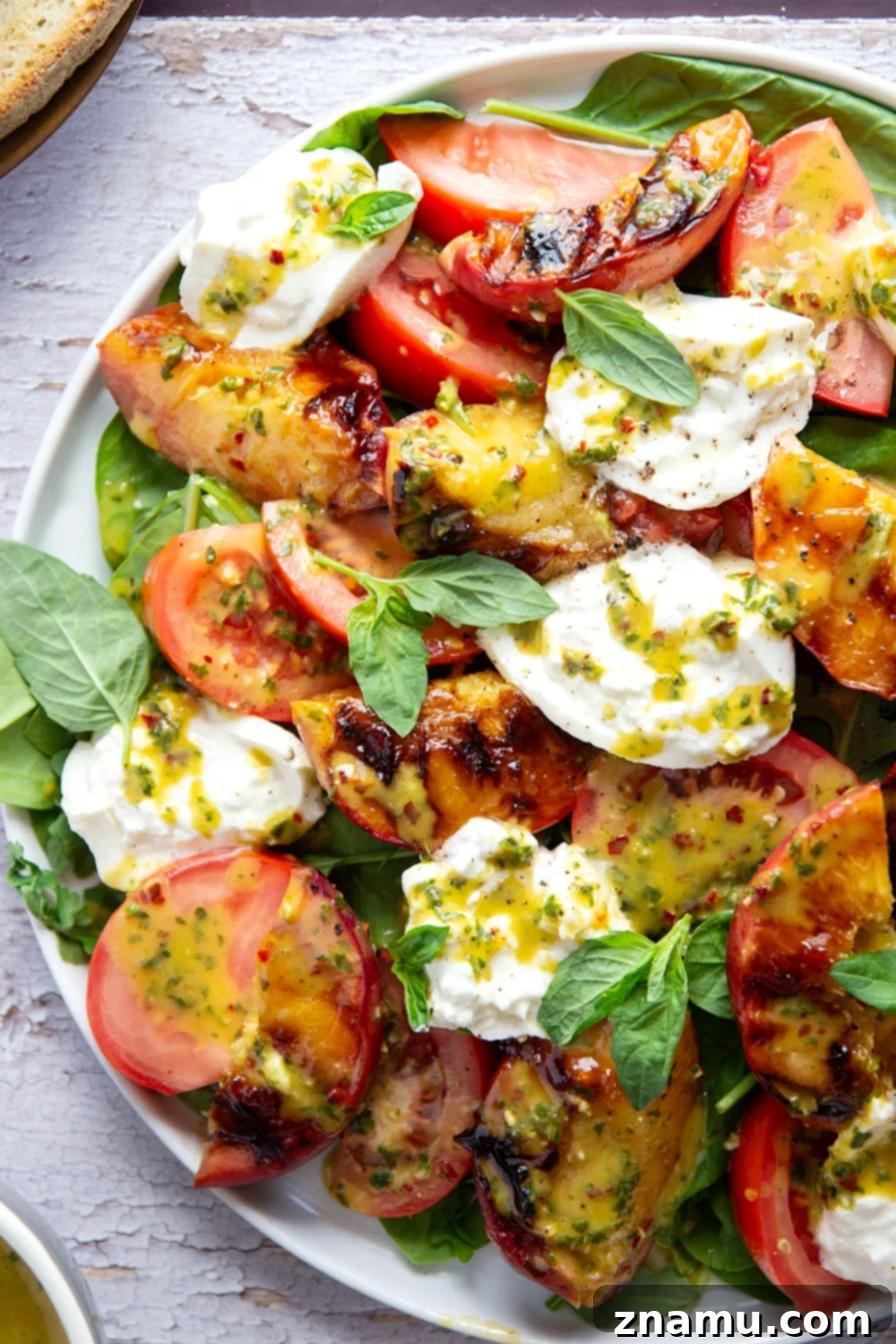 Sweet Ember Burrata with Zesty Basil Spark 3 Close-up of grilled peach burrata salad, highlighting the fresh ingredients and vibrant colors.