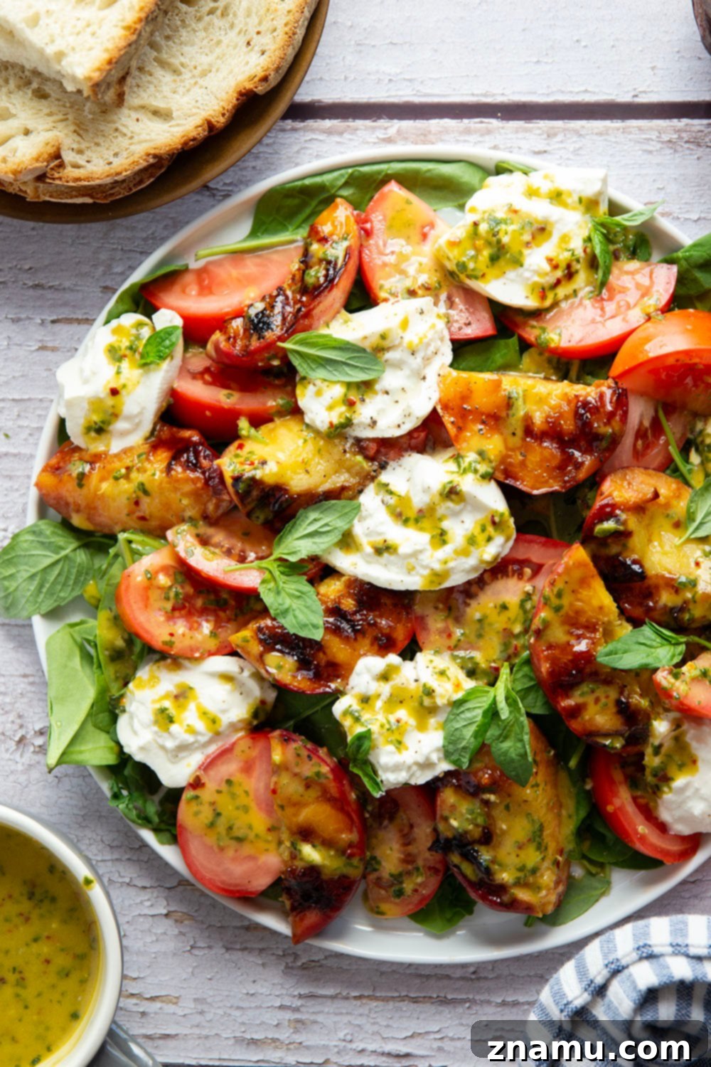 Sweet Ember Burrata with Zesty Basil Spark 5 A serving of grilled peach burrata salad with a rustic wooden background, ready to be enjoyed.