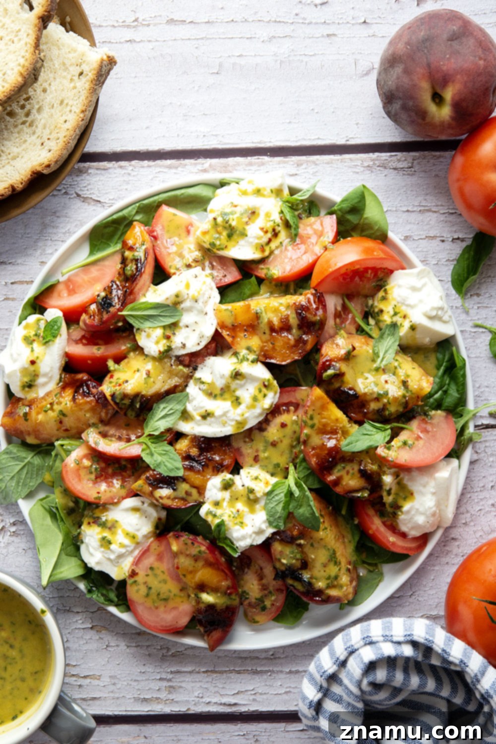 Sweet Ember Burrata with Zesty Basil Spark 6 A beautifully plated grilled peach burrata salad, showcasing its fresh and inviting appearance.