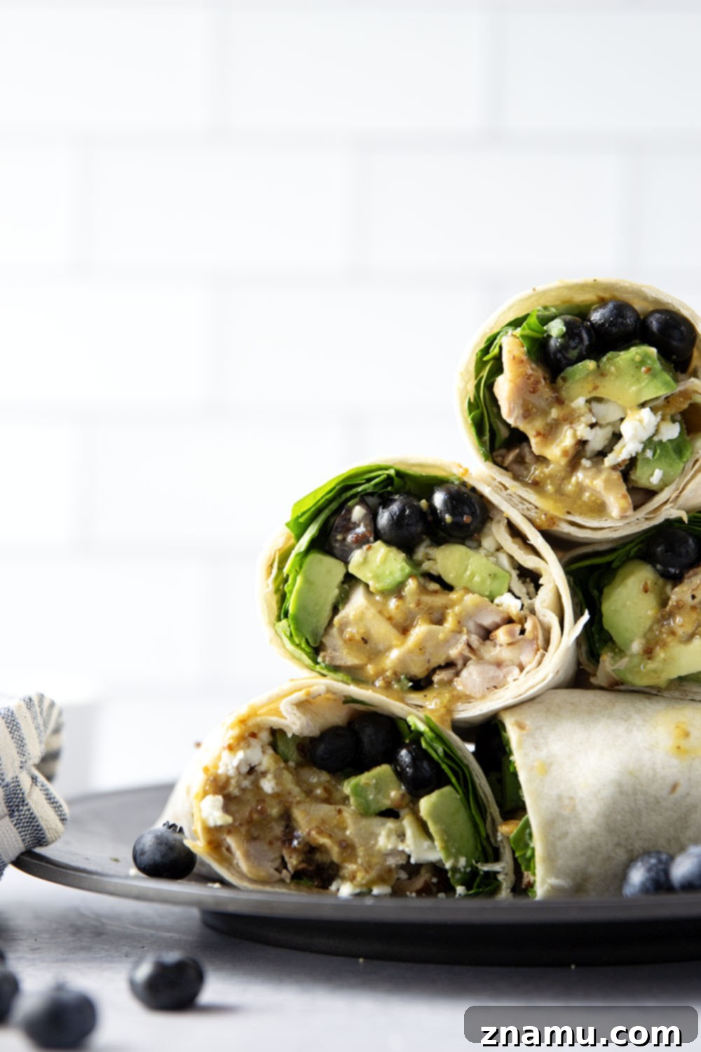 Stuffed with juicy honey mustard grilled chicken, sweet blueberries, silky avocado, and lots of greens, this honey mustard chicken wrap is easy to prep ahead of time for a stellar lunch!