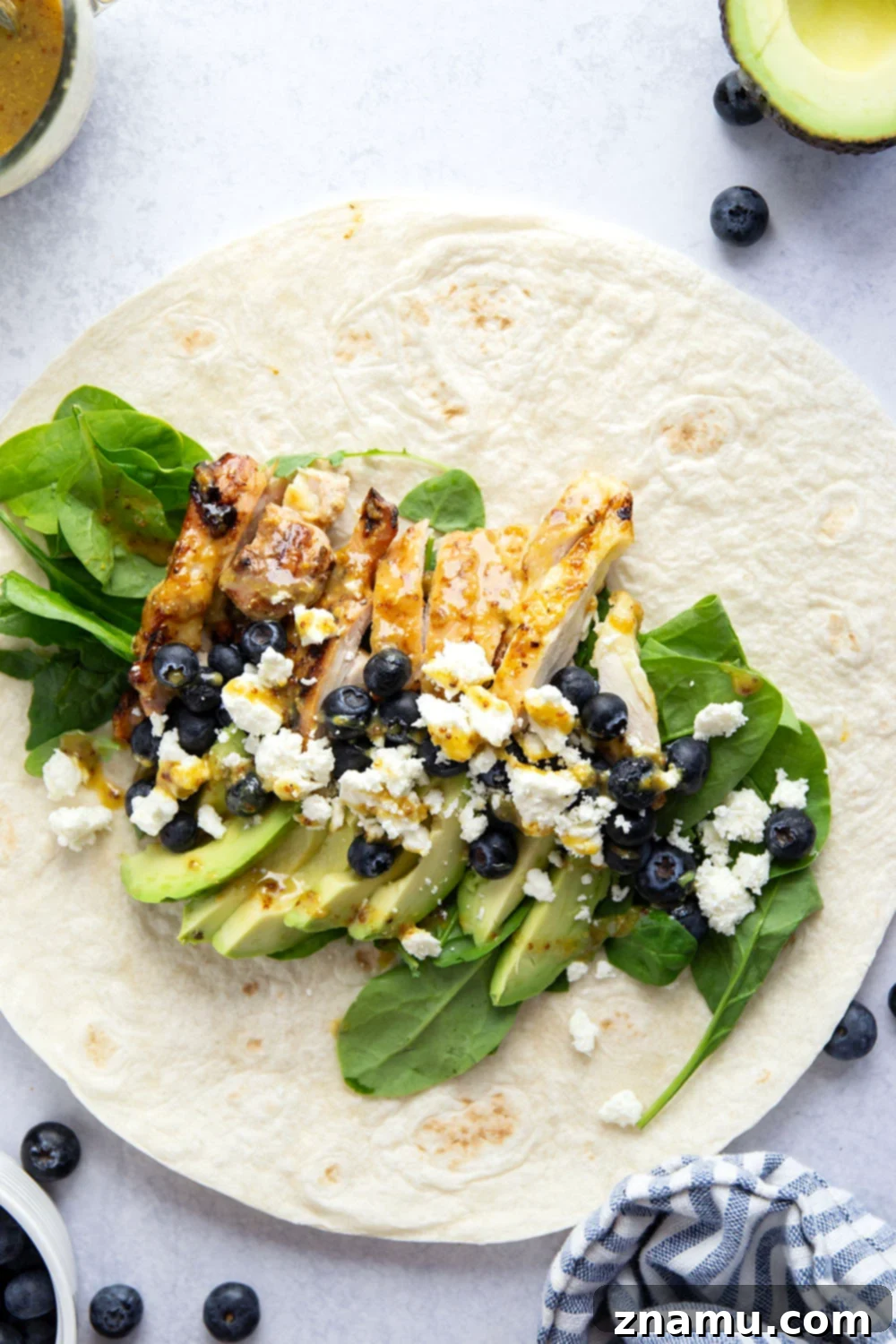 Stuffed with juicy honey mustard grilled chicken, sweet blueberries, silky avocado, and lots of greens, this honey mustard chicken wrap is easy to prep ahead of time for a stellar lunch!