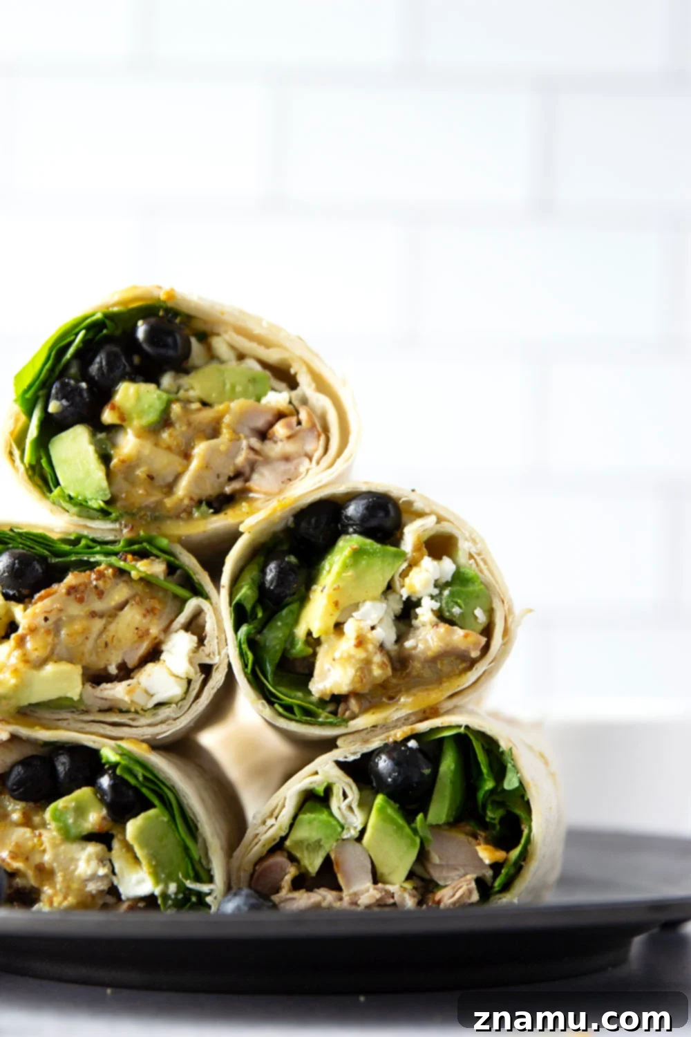 Stuffed with juicy honey mustard grilled chicken, sweet blueberries, silky avocado, and lots of greens, this honey mustard chicken wrap is easy to prep ahead of time for a stellar lunch!