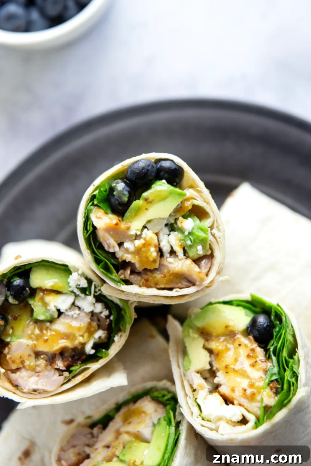 Stuffed with juicy honey mustard grilled chicken, sweet blueberries, silky avocado, and lots of greens, this honey mustard chicken wrap is easy to prep ahead of time for a stellar lunch!