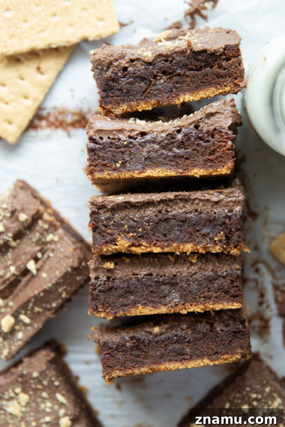 Golden Graham Brownies, Crowned with Whipped Chocolate Ganache 4 These graham cracker brownies feature a fudgy brownie layer baked on top of a buttery graham cracker crust base and topped with fluffy whipped chocolate ganache.