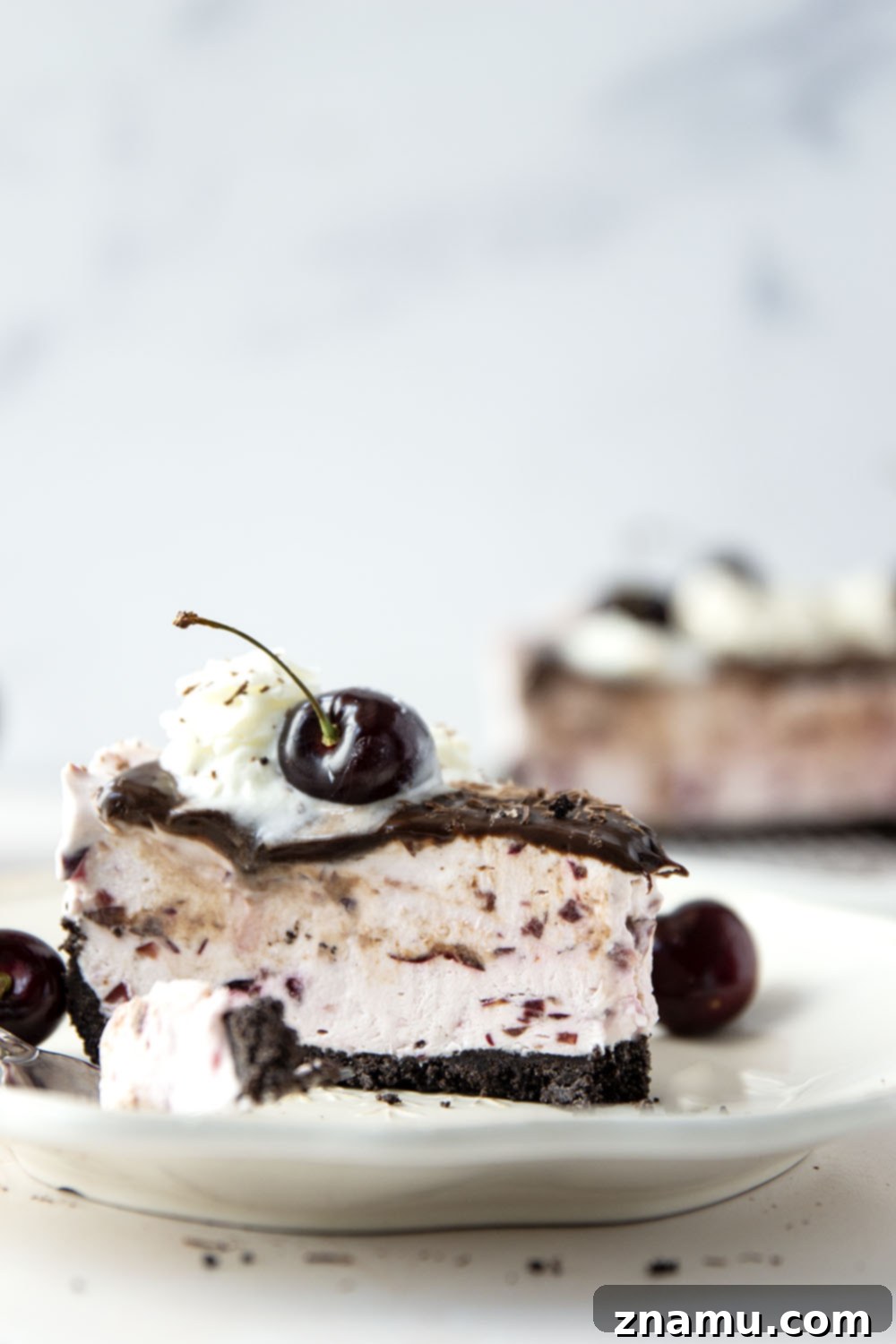Black Forest Frozen Cheesecake 6 This frozen black forest cheesecake is completely no-bake and features a buttery Oreo crust, silky cherry cheesecake filling, and lots of hot fudge sauce on top.