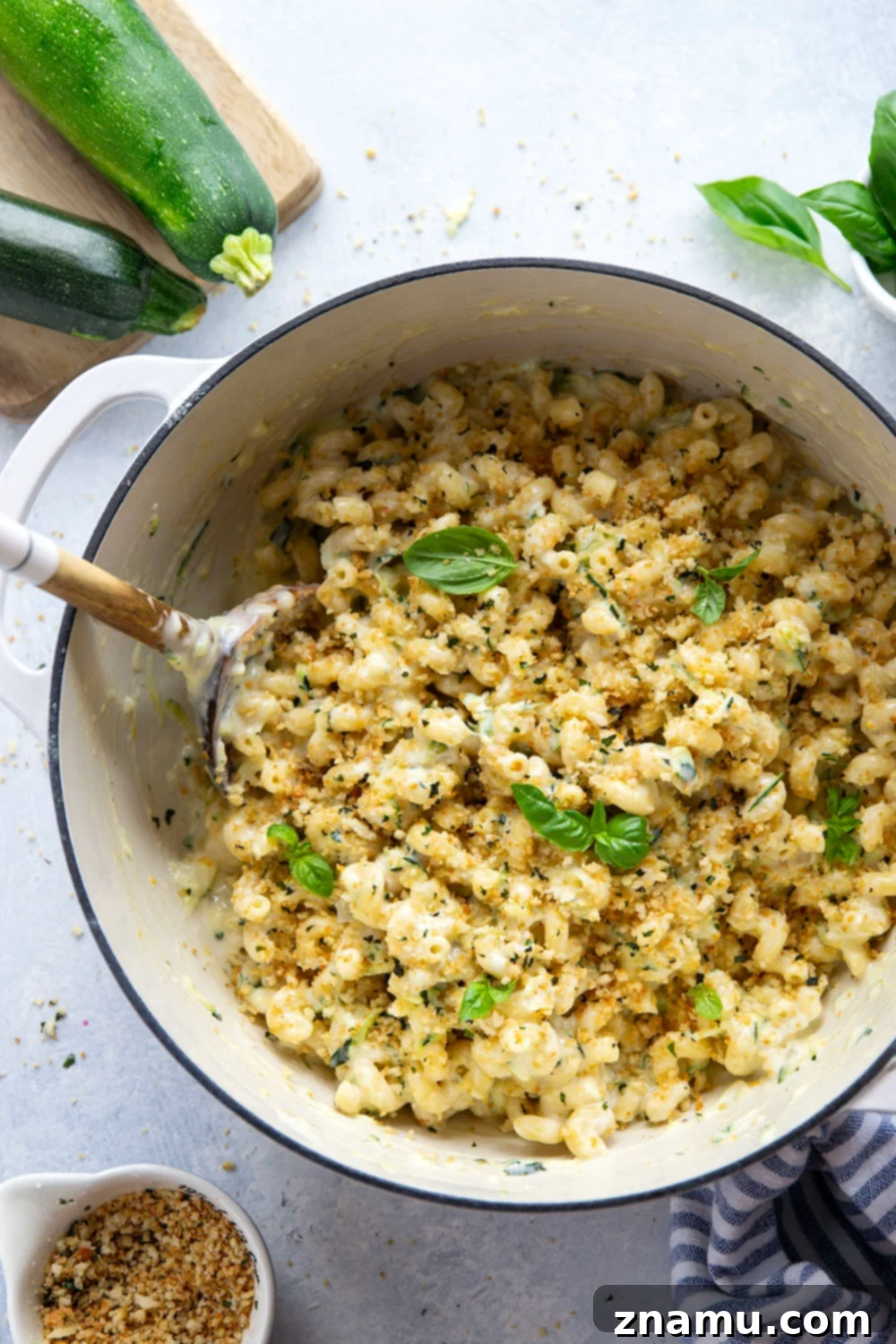 Creamy One-Pot Zucchini Mac and Cheese 2 Creamy One-Pot Zucchini Mac and Cheese with shredded zucchini, golden breadcrumbs, and fresh basil.