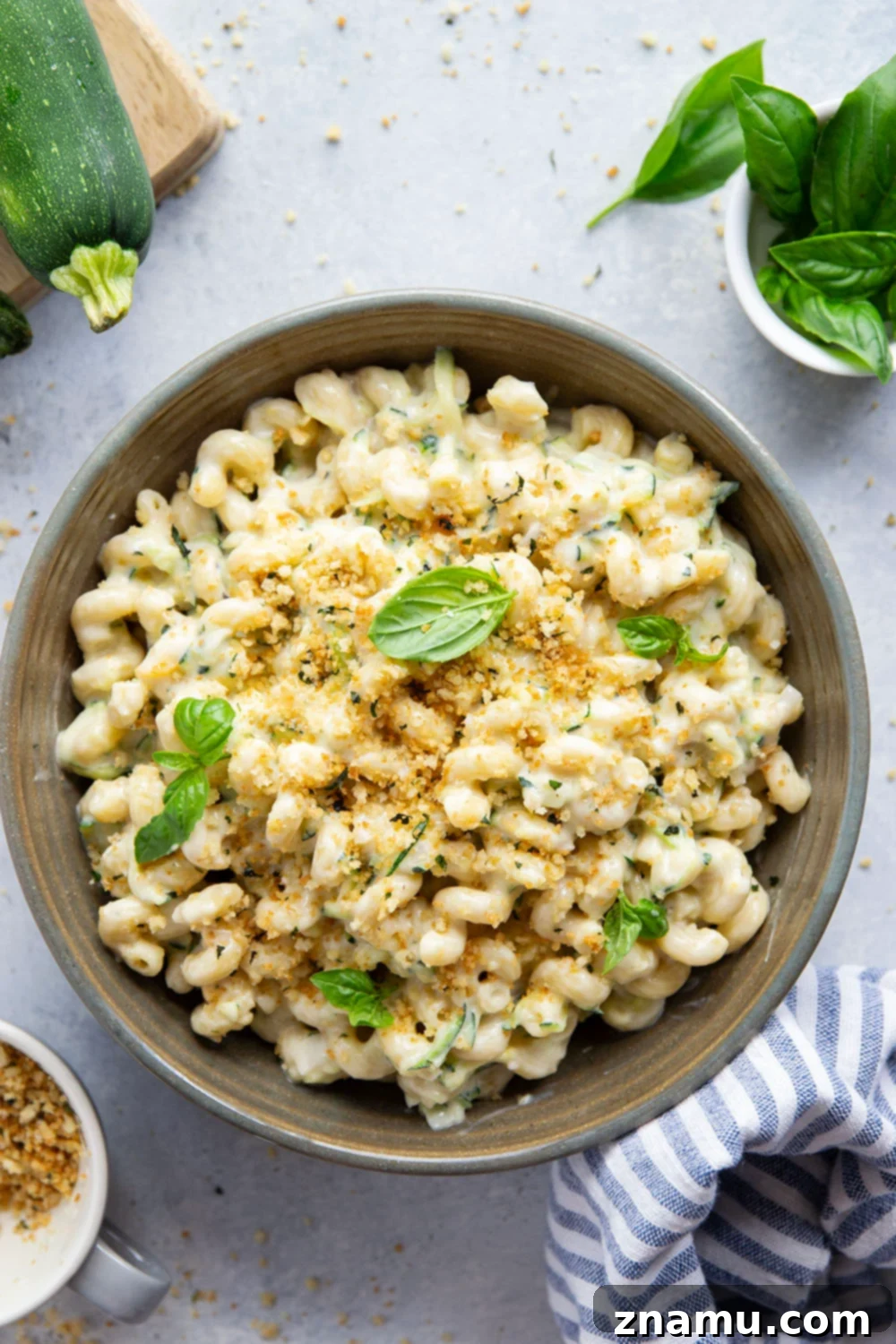 Creamy One-Pot Zucchini Mac and Cheese 4 Close-up of golden basil Parmesan breadcrumbs sprinkled over mac and cheese.