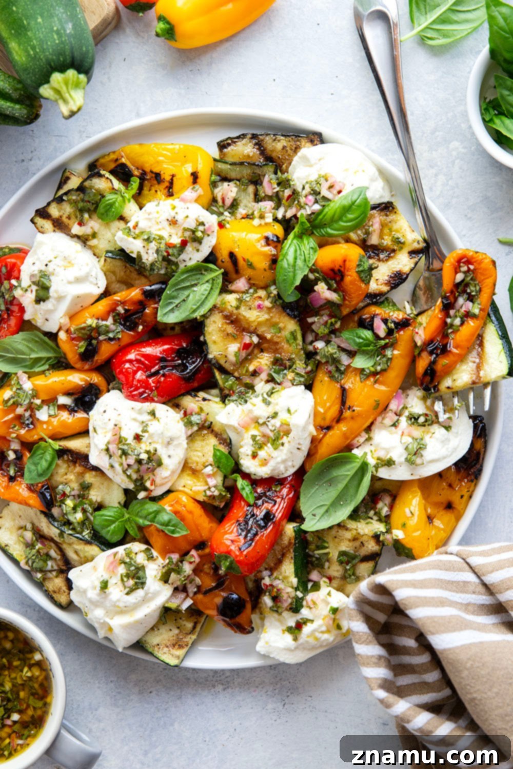 Smoky Grilled Vegetables, Creamy Burrata, Zesty Chimichurri 2 Flavorful grilled zucchini and sweet peppers, served with rich burrata cheese and a zesty chimichurri, perfect for a quick and easy summer side dish.