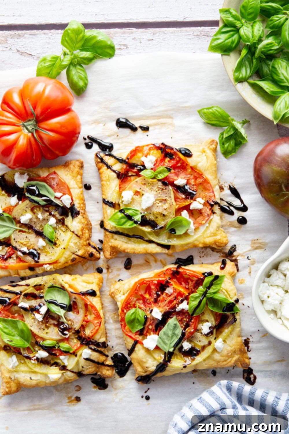 Jewel-Toned Heirloom Tomato Tarts with Tangy Goat Cheese 2 Flaky puff pastry is baked with a sweet heirloom tomato filling and lots of flavorful goat cheese in these easy heirloom tomato tarts!