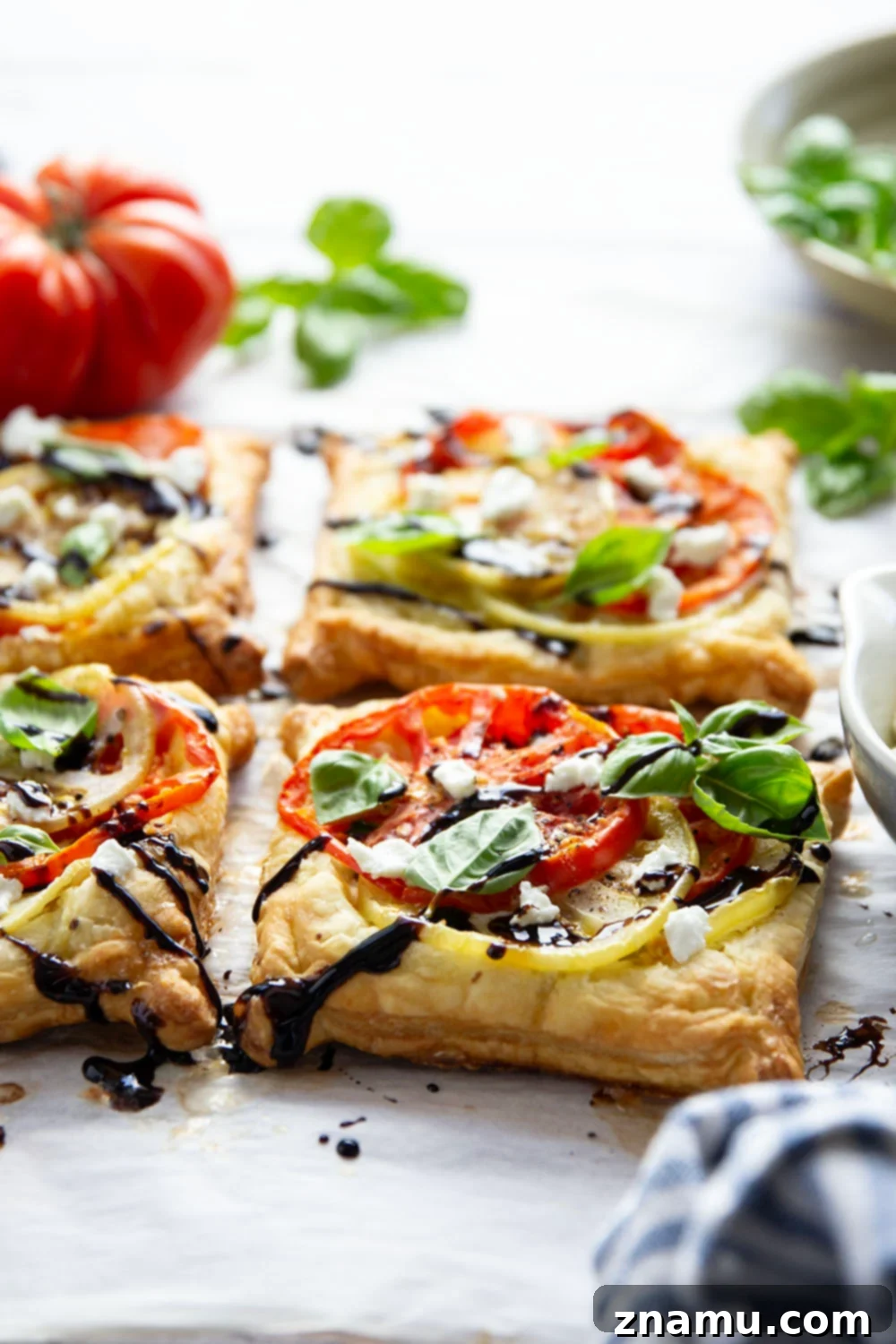 Jewel-Toned Heirloom Tomato Tarts with Tangy Goat Cheese 3 Flaky puff pastry is baked with a sweet heirloom tomato filling and lots of flavorful goat cheese in these easy heirloom tomato tarts!