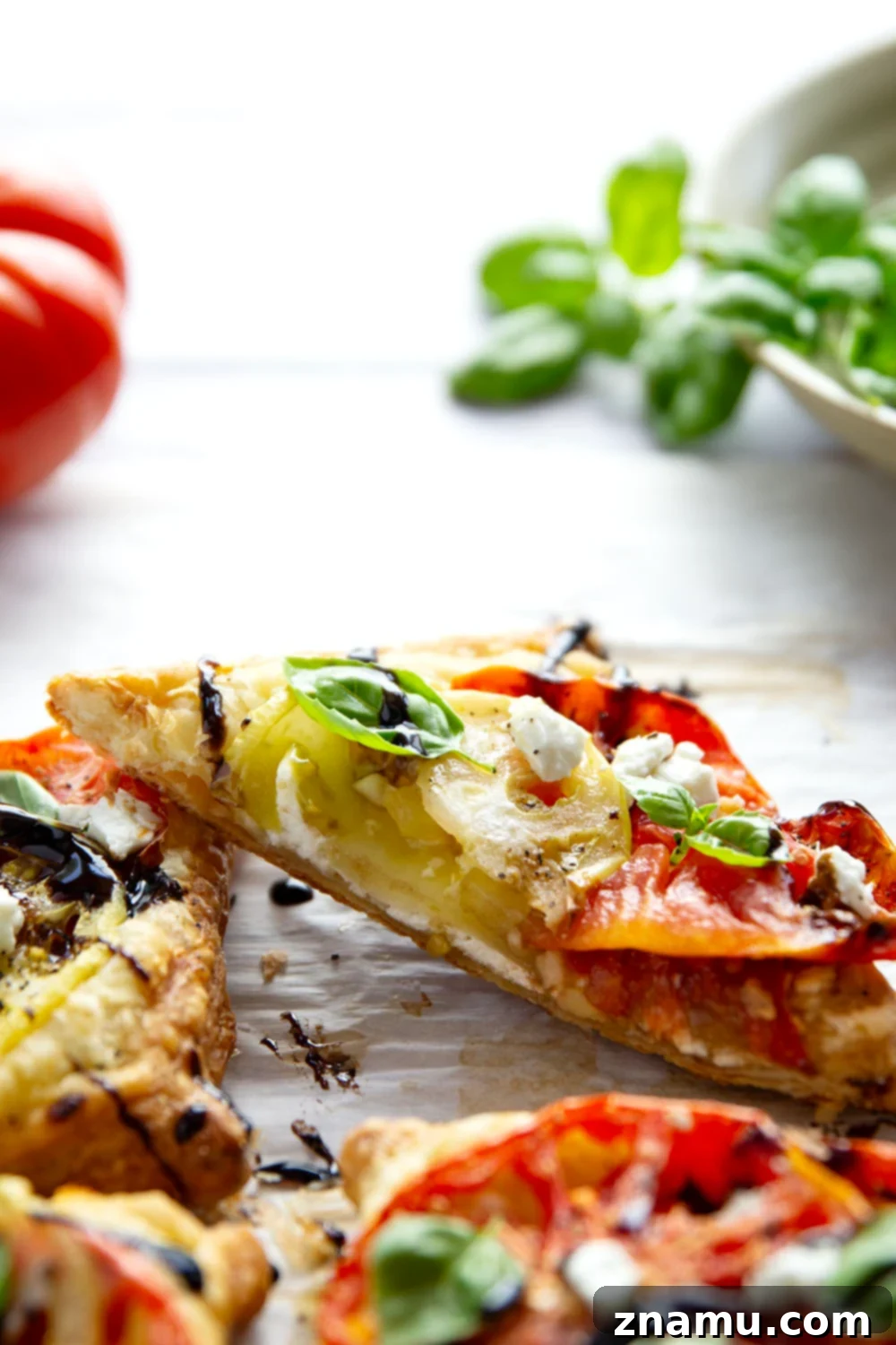 Jewel-Toned Heirloom Tomato Tarts with Tangy Goat Cheese 6 Flaky puff pastry is baked with a sweet heirloom tomato filling and lots of flavorful goat cheese in these easy heirloom tomato tarts!