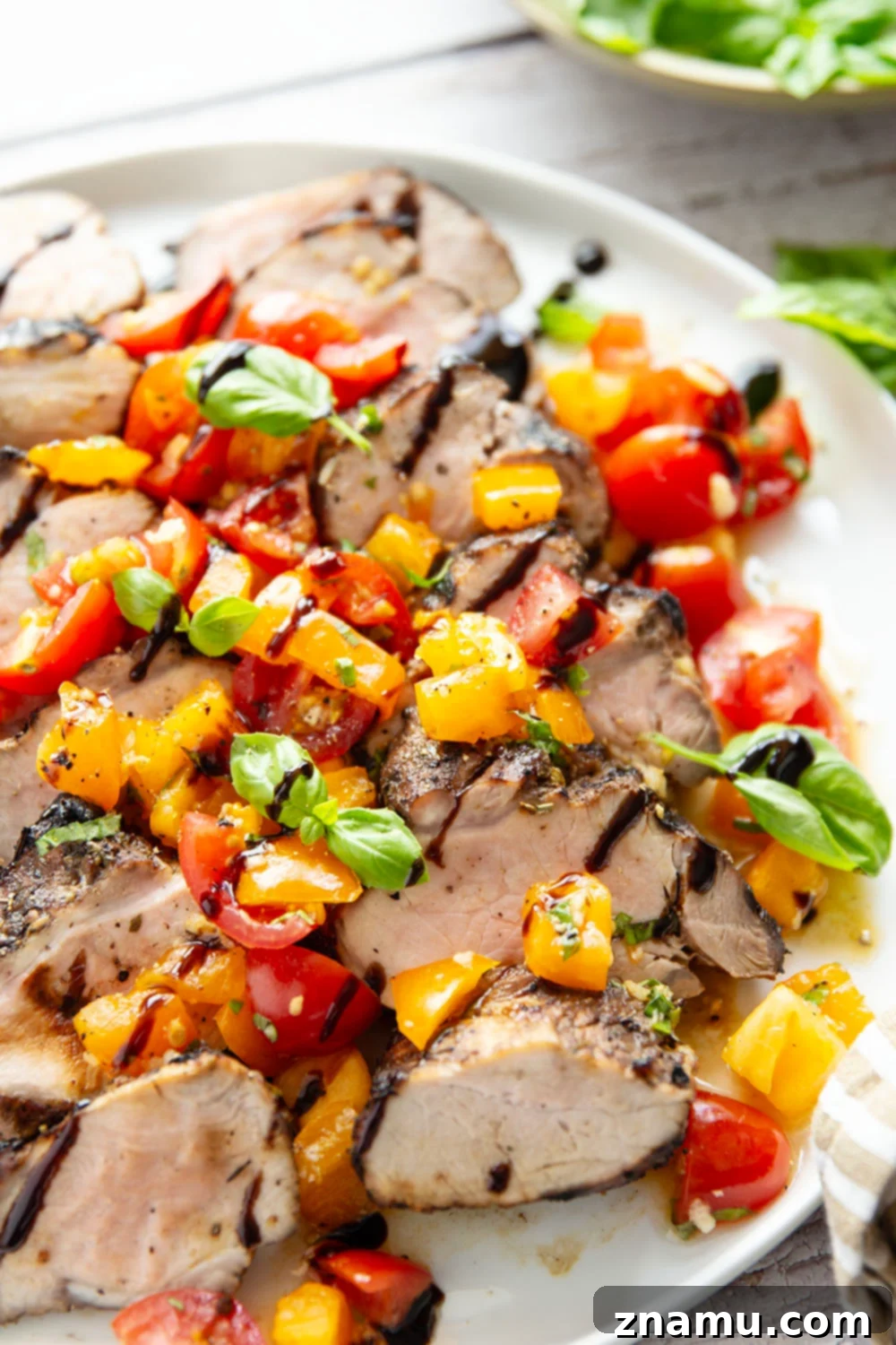 Grilled Pork Loin with Zesty Bruschetta 4 Grilled pork loin platter ready for serving, showcasing the fresh bruschetta and balsamic glaze