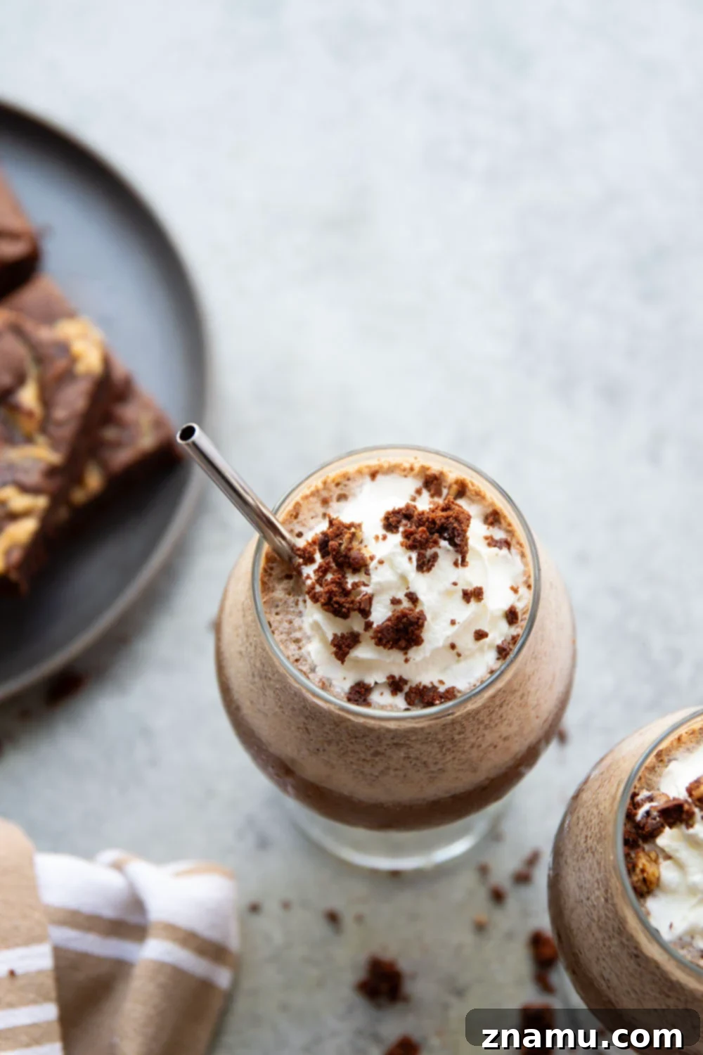 Fudgy Mocha Freeze 4 Ingredients for a Brownie Mocha Frappuccino arranged on a wooden surface, ready for blending