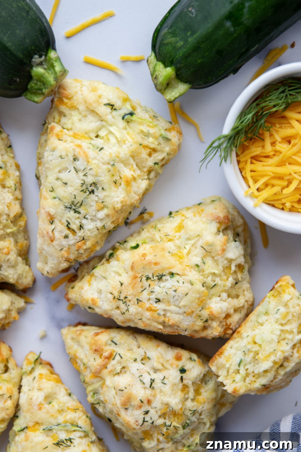 Bright Dill Cheddar Zucchini Scones 5 Shredded zucchini being squeezed in a kitchen towel to remove excess moisture, a key step for perfect scones.