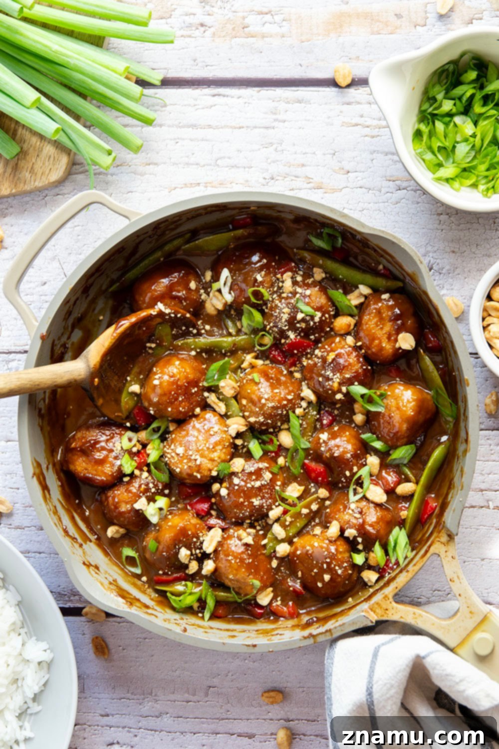 Nutty Satay Chicken Bites 3 A bowl of Peanut Chicken Satay Meatballs with tender snow peas and sweet peppers
